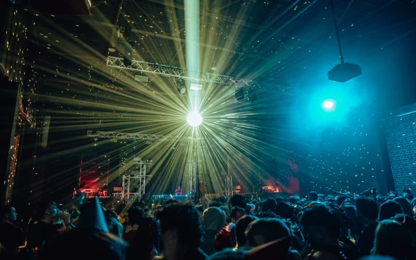 Large mirror ball reflecting beams of light across the audience at Testbed Leeds