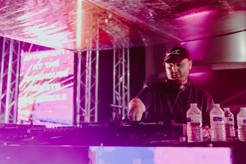Cru2 Leeds Shutdown - DJ performing under pink stage lighting